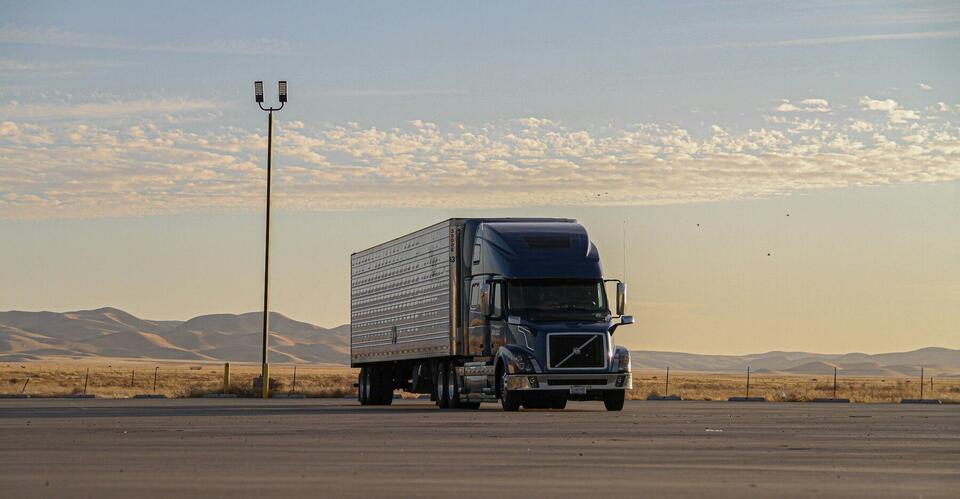 Volvo VNL tractor and 53-foot dry van parked at sunset
