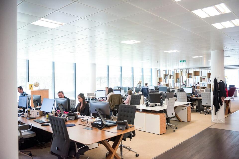 Open-plan logistics operations office with staff at workstations